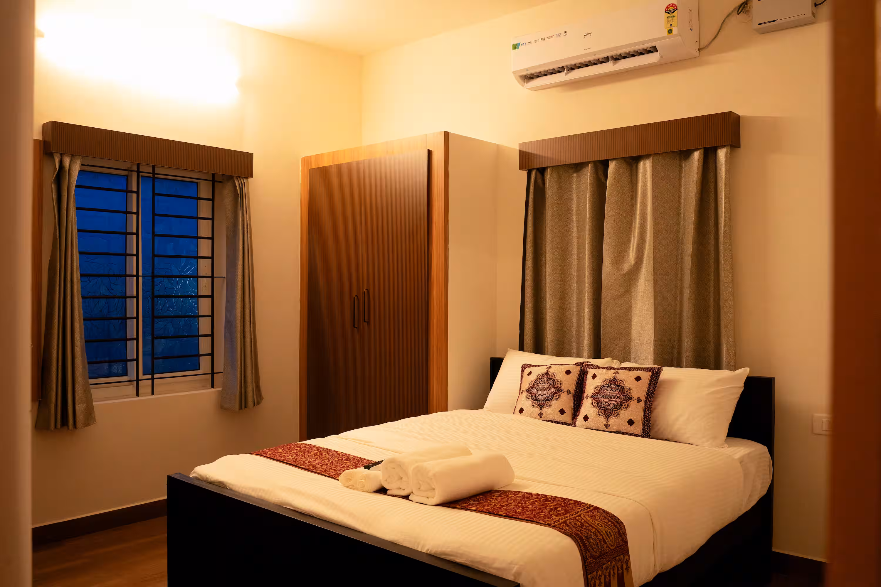 The Aranya king-bed guest room with wardrobe, air conditioning and two windows