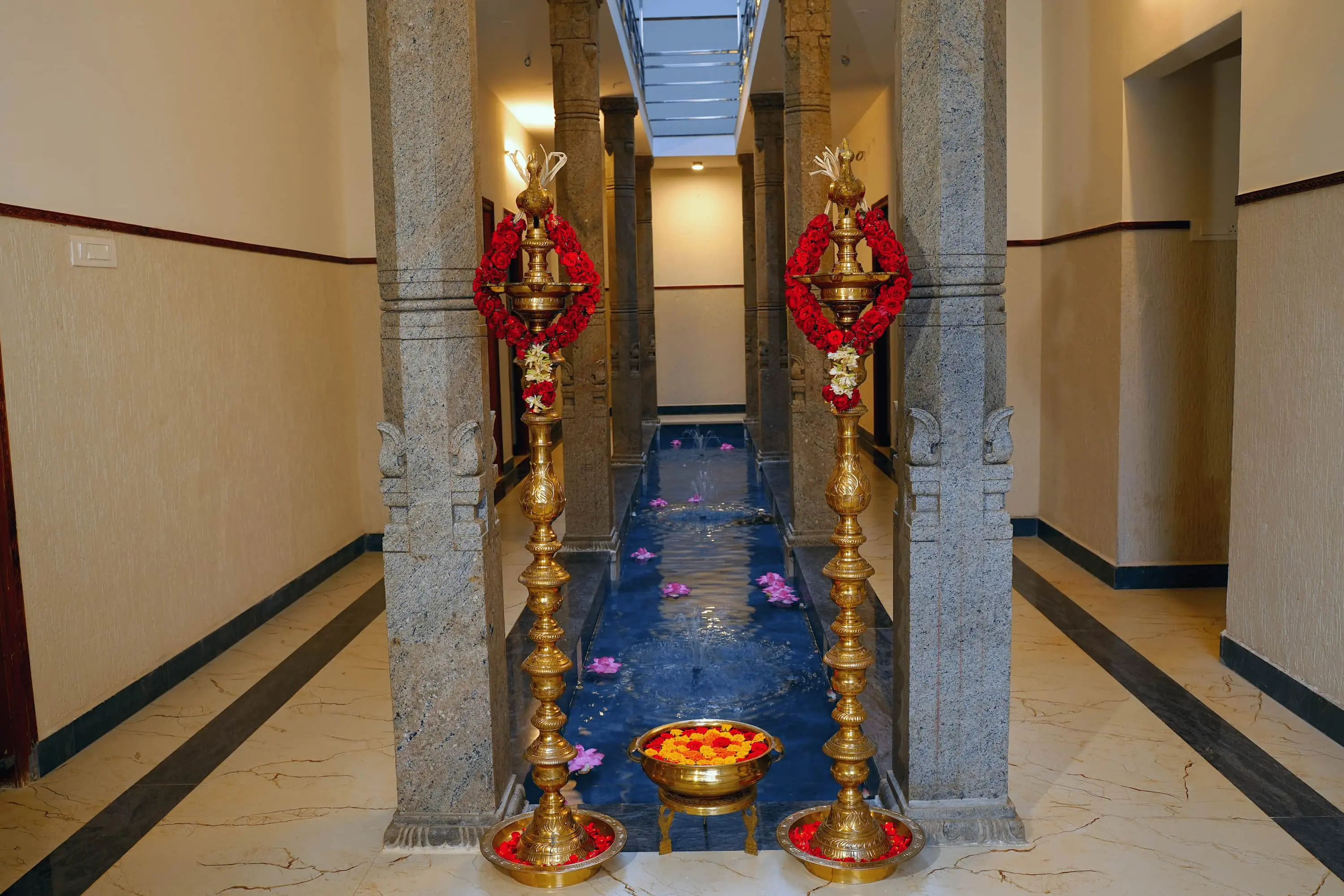 Traditional stone pillars at Aranya boutique hotel in Thanjavur